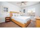 Bedroom featuring a double bed with light wood frame and nightstands at 8545 Bay Lilly Loop, Kissimmee, FL 34747