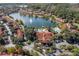Aerial view of community with lake, pool, clubhouse, and lush landscaping at 8545 Bay Lilly Loop, Kissimmee, FL 34747