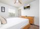 Bedroom with double bed, dresser, and wall-mounted TV at 8545 Bay Lilly Loop, Kissimmee, FL 34747