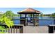 Wooden dock and gazebo on a lake with scenic views at 8545 Bay Lilly Loop, Kissimmee, FL 34747