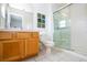 Clean bathroom with wood vanity, toilet, and glass shower at 8545 Bay Lilly Loop, Kissimmee, FL 34747