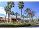 Encantada community entrance with lush landscaping and palm trees at 8545 Bay Lilly Loop, Kissimmee, FL 34747