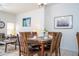 Dining area with wood table and chairs, adjacent to living room at 8545 Bay Lilly Loop, Kissimmee, FL 34747