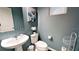 Stylish bathroom with pedestal sink and modern toilet at 5144 Adelaide Dr, Kissimmee, FL 34746