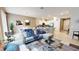 Open living room with grey sectional sofa and a view into the kitchen at 5144 Adelaide Dr, Kissimmee, FL 34746