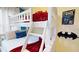White bunk beds with red bedding and superhero decor at 5144 Adelaide Dr, Kissimmee, FL 34746