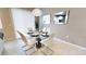 Bright dining room with glass table and white chairs, perfect for Gathering meals at 5144 Adelaide Dr, Kissimmee, FL 34746