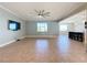Bright living room with tile floors, ceiling fan, and views of the kitchen at 3510 Mediterra Dr, Clermont, FL 34711