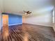 Spacious bedroom with wood-look floors and access to a bathroom at 3510 Mediterra Dr, Clermont, FL 34711