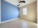 Bedroom with blue accent wall, ceiling fan, and tile floors at 3510 Mediterra Dr, Clermont, FL 34711