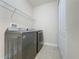 Laundry room with washer, dryer, shelving and extra storage at 3510 Mediterra Dr, Clermont, FL 34711