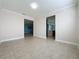 Neutral-toned dining room with tile floors and access to the living room at 3510 Mediterra Dr, Clermont, FL 34711