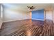 Large bedroom with ceiling fan, wood-look floors and blue accent wall at 3510 Mediterra Dr, Clermont, FL 34711