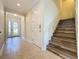 Bright entryway with tile flooring, leading to stairs and other rooms at 3510 Mediterra Dr, Clermont, FL 34711