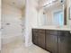 Bathroom with tub shower combo, vanity, and tile flooring at 3510 Mediterra Dr, Clermont, FL 34711