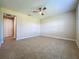Spacious bedroom with neutral walls, ceiling fan, and tile floors at 3510 Mediterra Dr, Clermont, FL 34711