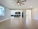 Open living room with tile floors and views into the kitchen at 3510 Mediterra Dr, Clermont, FL 34711
