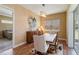 Charming dining room with wooden table, chandelier, and access to patio at 5006 Sunfalls Ave, Saint Cloud, FL 34772