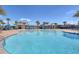 Large community pool with multiple seating areas and a view of the clubhouse at 5006 Sunfalls Ave, Saint Cloud, FL 34772
