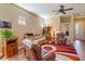 Living room with hardwood floors, comfortable seating, and a view of the backyard at 5006 Sunfalls Ave, Saint Cloud, FL 34772