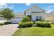 One-story home with light gray siding, white door, and brick paver driveway at 5006 Sunfalls Ave, Saint Cloud, FL 34772