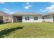 House exterior with screened porch and grassy backyard at 5006 Sunfalls Ave, Saint Cloud, FL 34772