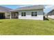 House exterior with screened patio and grassy backyard at 5006 Sunfalls Ave, Saint Cloud, FL 34772
