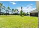 Spacious backyard with grassy lawn, pool, and patio at 5006 Sunfalls Ave, Saint Cloud, FL 34772