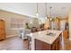Kitchen with an island, pendant lighting, and view into the living room at 5006 Sunfalls Ave, Saint Cloud, FL 34772