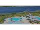 Aerial view of community pool and clubhouse with lake views at 5006 Sunfalls Ave, Saint Cloud, FL 34772