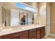 Modern bathroom with dual vanities and a large mirror reflecting a walk-in closet at 5006 Sunfalls Ave, Saint Cloud, FL 34772