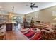 Open living room with hardwood floors, a large rug, and access to kitchen at 5006 Sunfalls Ave, Saint Cloud, FL 34772