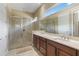Elegant bathroom with dual vanities, a large shower, and a bright window at 5006 Sunfalls Ave, Saint Cloud, FL 34772