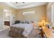Charming bedroom with a double bed, a view of the bathroom, and a convenient workspace at 5006 Sunfalls Ave, Saint Cloud, FL 34772