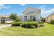 Side view of a one-story house with gray siding, landscaping, and walkway at 5006 Sunfalls Ave, Saint Cloud, FL 34772