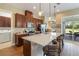Spacious kitchen with island, stainless steel appliances, and access to backyard at 5006 Sunfalls Ave, Saint Cloud, FL 34772