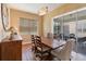 Bright dining area with wooden table and access to backyard patio at 5006 Sunfalls Ave, Saint Cloud, FL 34772