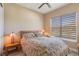 Comfortable bedroom with a floral bedspread and a window offering natural light at 5006 Sunfalls Ave, Saint Cloud, FL 34772