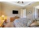 Spacious bedroom with a dresser, TV, and an ensuite bathroom at 5006 Sunfalls Ave, Saint Cloud, FL 34772