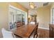 Bright dining room featuring a rustic wooden table and access to a relaxing patio at 5006 Sunfalls Ave, Saint Cloud, FL 34772