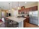 Modern kitchen featuring a large island, stainless steel appliances, and hardwood floors at 5006 Sunfalls Ave, Saint Cloud, FL 34772
