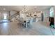 Open kitchen with white cabinetry, large island and dining area at 2867 Matera Dr, St Cloud, FL 34771
