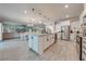 Modern kitchen with large island, stainless steel appliances, and pantry at 2867 Matera Dr, St Cloud, FL 34771
