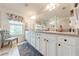 Double vanity bathroom with a large mirror and window at 2867 Matera Dr, St Cloud, FL 34771