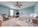 Bright bedroom with carpeted floor, ceiling fan, and built-in workspace at 2867 Matera Dr, Saint Cloud, FL 34771