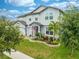 Two-story house with a three-car garage, lush landscaping and a flag at 2867 Matera Dr, St Cloud, FL 34771