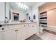 Bathroom with double sinks, white cabinets, and gray tile floor at 2867 Matera Dr, St Cloud, FL 34771