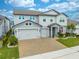 Two-story house with a three-car garage and a well-manicured lawn at 2867 Matera Dr, Saint Cloud, FL 34771