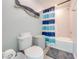 Small bathroom with tub shower, and blue striped curtain at 2867 Matera Dr, St Cloud, FL 34771