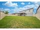 Fenced backyard with grassy lawn and home at 2867 Matera Dr, St Cloud, FL 34771